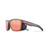 Julbo Shield sunglasses with polarized red-orange lenses and a matte burgundy frame with side shields, available at Matthew Sports.