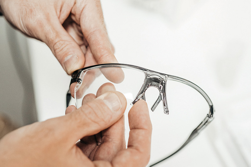 Person holding a pair of glasses