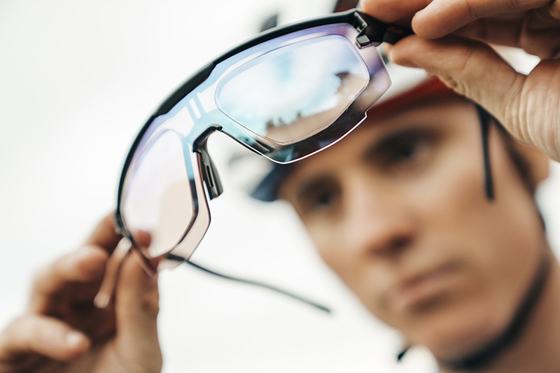 Person holding stylish sunglasses.